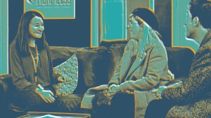 Three people sitting on a couch, engaged in a lively conversation. Image is rendered in blues and orange.