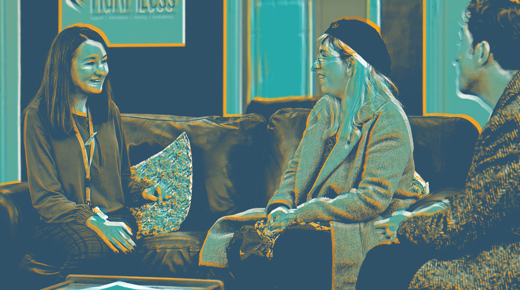 Three people sitting on a couch, engaged in a lively conversation. Image is rendered in blues and orange.