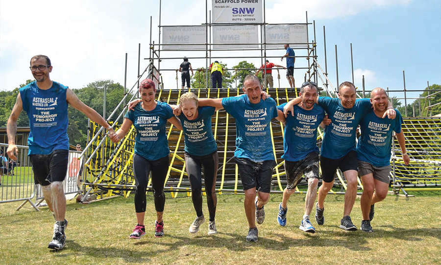 A team of fundraisers competing in an outdoor obstacle race.
